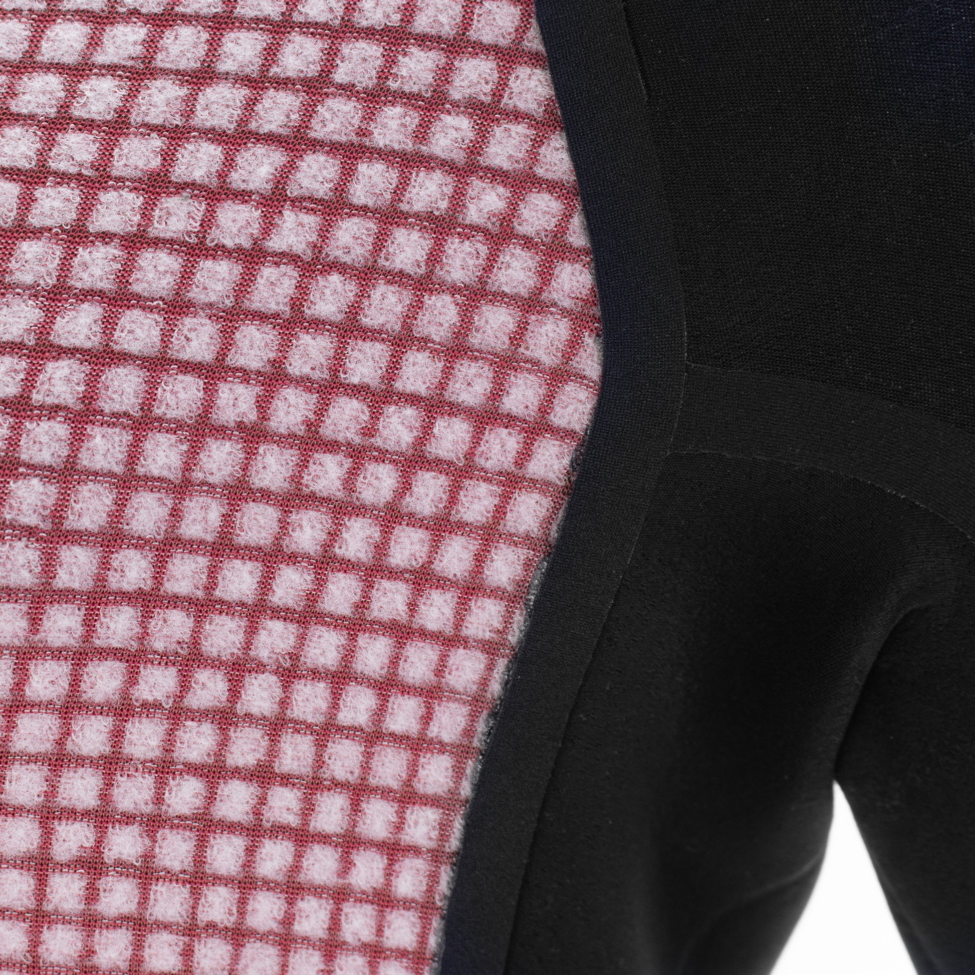 Close-up of the inside thermal lining on a canyoneering wetsuit showing the checker panel and seal tape 